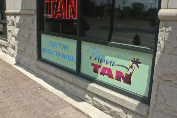 Maui Tan Arlington Heights.  Colorful logo with gradient pattern in text.